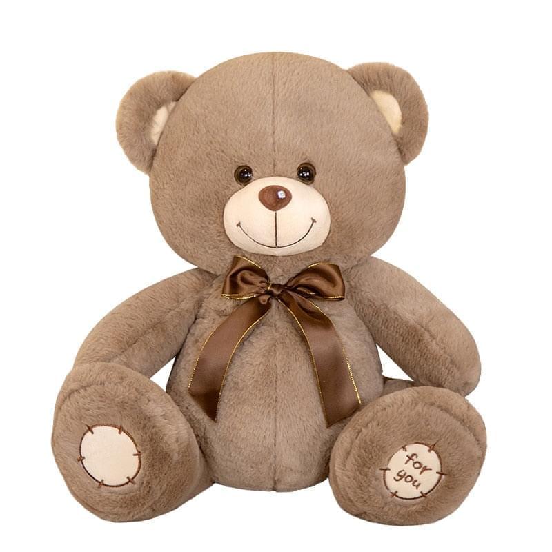 A cuddly and soft brown teddy bear with a satin bow and embroidered paw pads