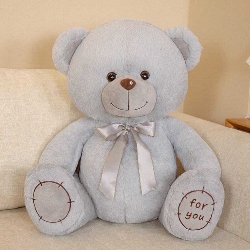 Soft stuffed bear with warm smile, seated and huggable | Blue color